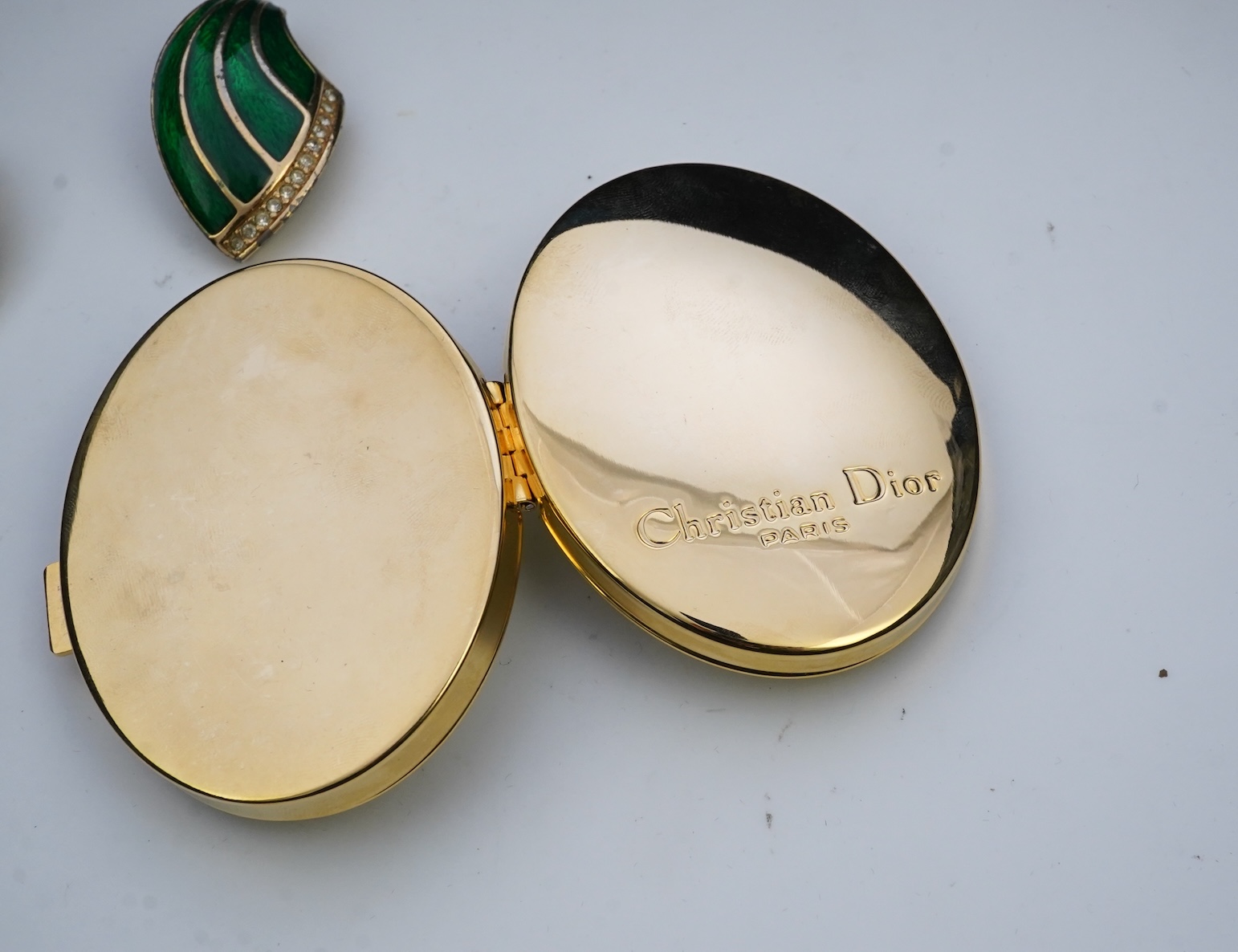 A pair of Christian Dior vintage earrings and compact mirror.